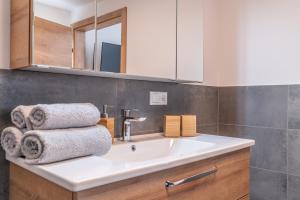 a bathroom with a sink with towels on it at Apart Crystal in Längenfeld