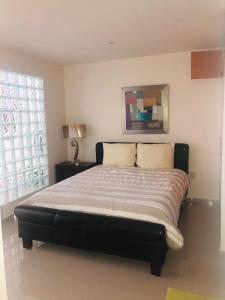 a large bed in a bedroom with a window at PuntaGaviota in Santa Cruz Huatulco
