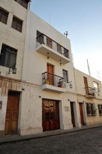 a white building with two balconies on top of it at Tambo del Solar in Arequipa