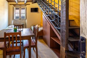 a dining room with a table and a staircase at APART LA VIÑA in Salta