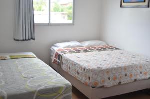 Postel nebo postele na pokoji v ubytování Hotel Paradise Beach