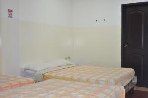 Postel nebo postele na pokoji v ubytování Hotel Paradise Beach