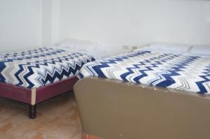 Postel nebo postele na pokoji v ubytování Hotel Paradise Beach