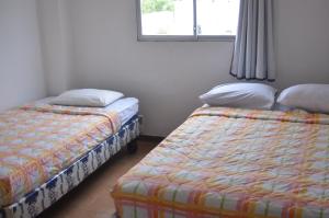 Postel nebo postele na pokoji v ubytování Hotel Paradise Beach