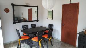 comedor con mesa, sillas y espejo en Chalet Ymaz en Villa Gesell