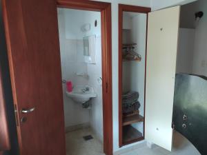 a small bathroom with a sink and a mirror at Chalet Ymaz in Villa Gesell