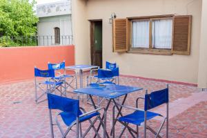 a group of blue tables and chairs in front of a building at La San Francisco II in Salta