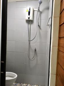 a shower in a bathroom with a toilet at Life and Love house in Ban Na Noi
