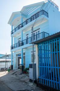 a blue and white house with a balcony at Xuan Anh Guesthouse in Phu Quoc