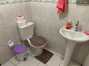 a bathroom with a toilet and a sink at Casa do Cais in Abraão