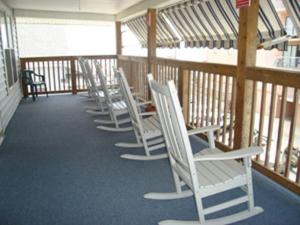 a row of chairs and tables in a room at Beach Walk Hotel in Ocean City