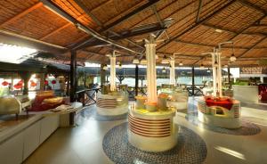 a restaurant with a lot of tables and chairs at Paya Beach Spa & Dive Resort in Tioman Island
