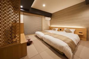 a bedroom with a large bed in a room at Rinn Gojo Karasuma in Kyoto