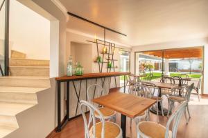a dining room with a table and chairs at 202 Hotel Boutique in Angol