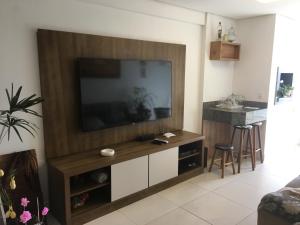 a living room with a large flat screen tv on a wall at Apartamento 601 3 Dormitórios in Torres