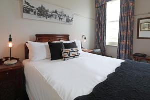 a bedroom with a large white bed and a window at Yarra Valley Grand in Yarra Glen