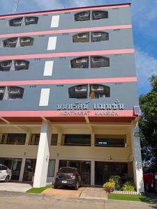 a building with a car parked in front of it at Nontharat Mansion in Nonthaburi