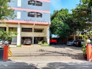 a building with a parking lot in front of it at Nontharat Mansion in Nonthaburi