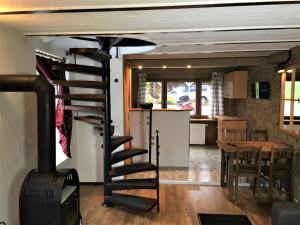 a spiral staircase in a living room with a kitchen at Haus Rothenberg in Nohfelden