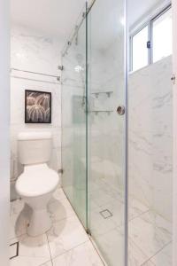a bathroom with a toilet and a glass shower at 1 Private Single Room in Carramar 1-minute walk to Station - ROOM ONLY in Sydney