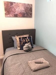 a bed with a stuffed animal on top of it at 1 Private Single Room in Carramar 1-minute walk to Station - ROOM ONLY in Sydney