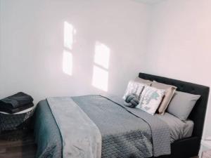 a bedroom with a bed with white walls and windows at 1 Private Double Room In Carramar 1-minute to Station - ROOM ONLY in Sydney
