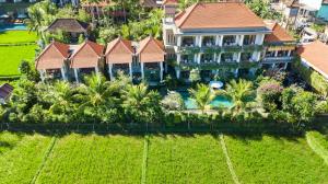 an aerial view of a house with a swimming pool at Kiskenda Cottages & Restaurant in Ubud