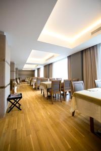 a large room with tables and chairs in it at Cihangir Hotel Bosphorus in Istanbul