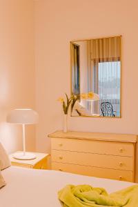 a bedroom with a dresser and a mirror at Bela Vista in Viana do Castelo