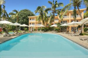 a large swimming pool in front of a hotel at Cocotiers Hotel - Rodrigues in Rodrigues Island