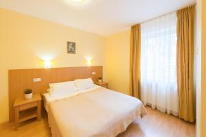 Postel nebo postele na pokoji v ubytování Hotel Vita