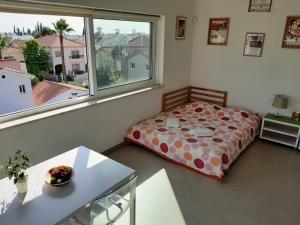a bedroom with a bed and a large window at Limassol sea view studio in Limassol