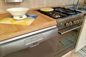a kitchen with a stove and a bowl on a counter at Ca'Noa in Valstagna +11 photos