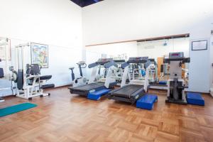 a gym with treadmills and elliptical machines at Terme Beach Resort in Punta Marina