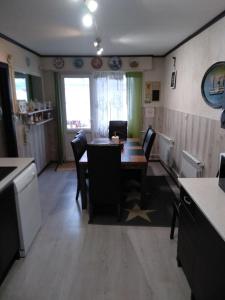 a kitchen with a table and chairs in a room at Cottage Viardo in Vehkataipale