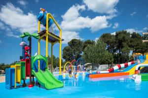 a swimming pool with a water park with a water slide at Holiday Centre Bi village in Fažana