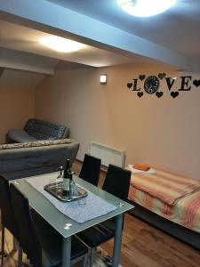 a room with a table and a bed and a table and chairs at APARTMANI MIA VUKSANOVIC in Cetinje