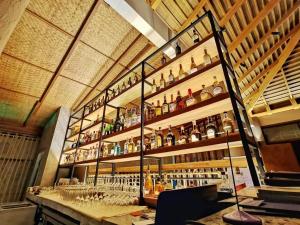 a bar with a lot of bottles and glasses at Kacha Resort & Spa, Koh Chang in Ko Chang