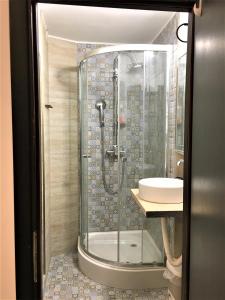 a bathroom with a shower and a sink at White Wolf Apartment in Braşov +20 photos
