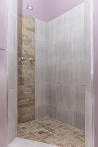 a bathroom with a shower with a tile floor at 10 Windell Self Catering Accommodation in Durbanville