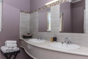 a bathroom with two sinks and two mirrors at 10 Windell Self Catering Accommodation in Durbanville