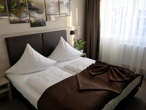 Postel nebo postele na pokoji v ubytování Hotel Glinde