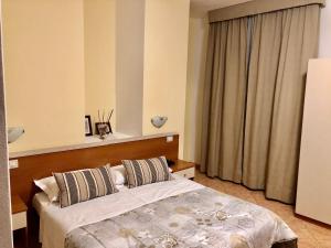 A bed or beds in a room at Hotel Ares Milano