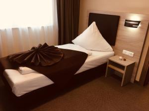 Postel nebo postele na pokoji v ubytování Hotel Glinde