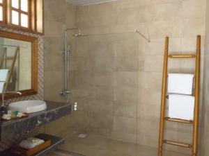a bathroom with a shower and a sink at Zanzibar Star Resort in Nungwi