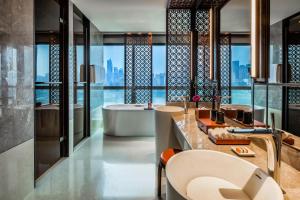 a bathroom with a tub and a view of the city at Regent Chongqing in Chongqing