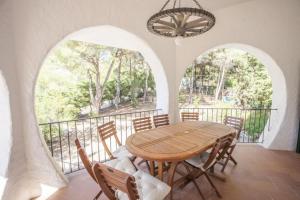 a dining room with a wooden table and chairs at Villa Sibilla - Goelba in Procchio +23 photos