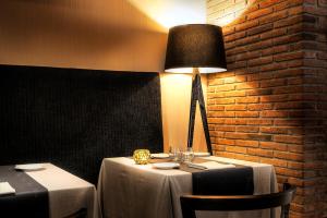 a table in a restaurant with a lamp on it at Silken Ramblas in Barcelona
