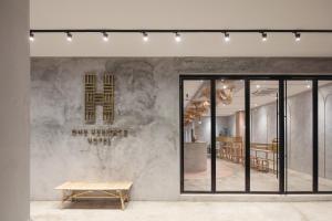 a store front with a bench and a table at One Heritage Hotel in Seremban