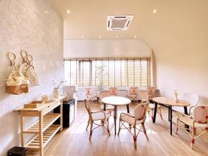a dining room with tables and chairs and a window at One Heritage Hotel in Seremban